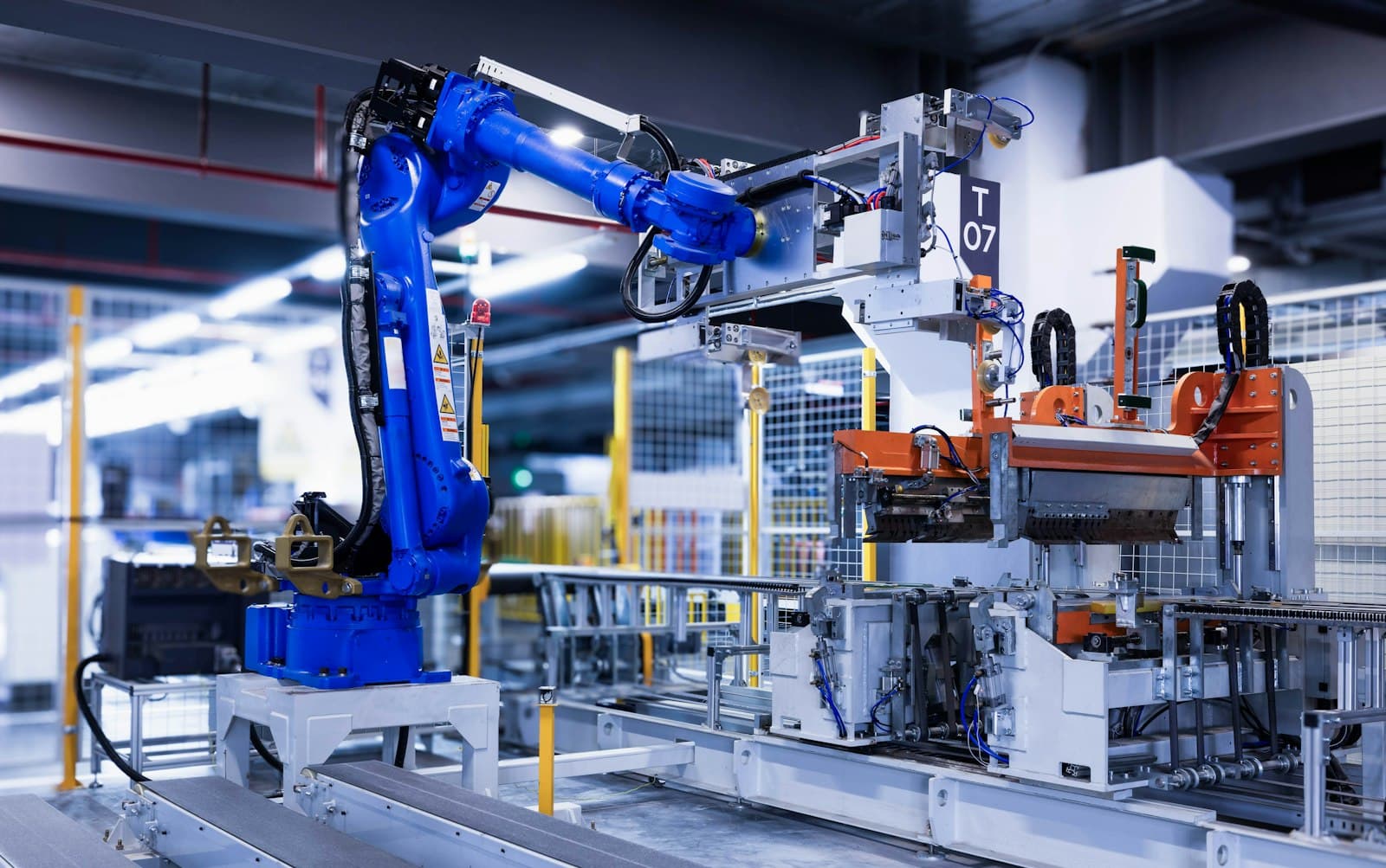 Blue industrial automation arm on a factory production line